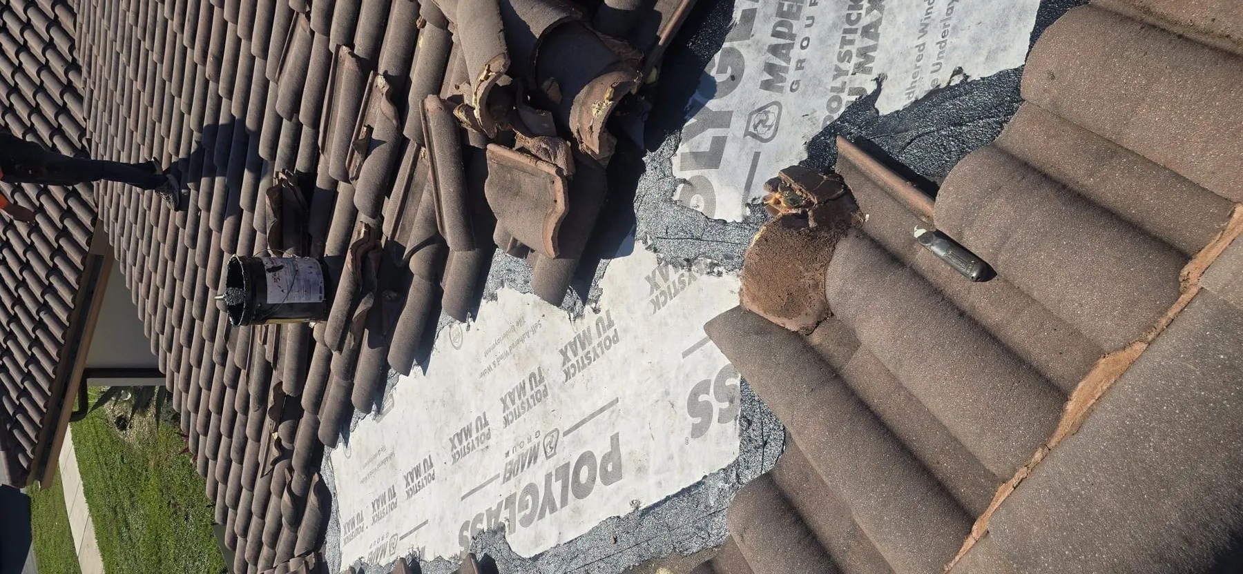 Tile roof in the middle of repair by DIOS ES MI FUERZA CORP