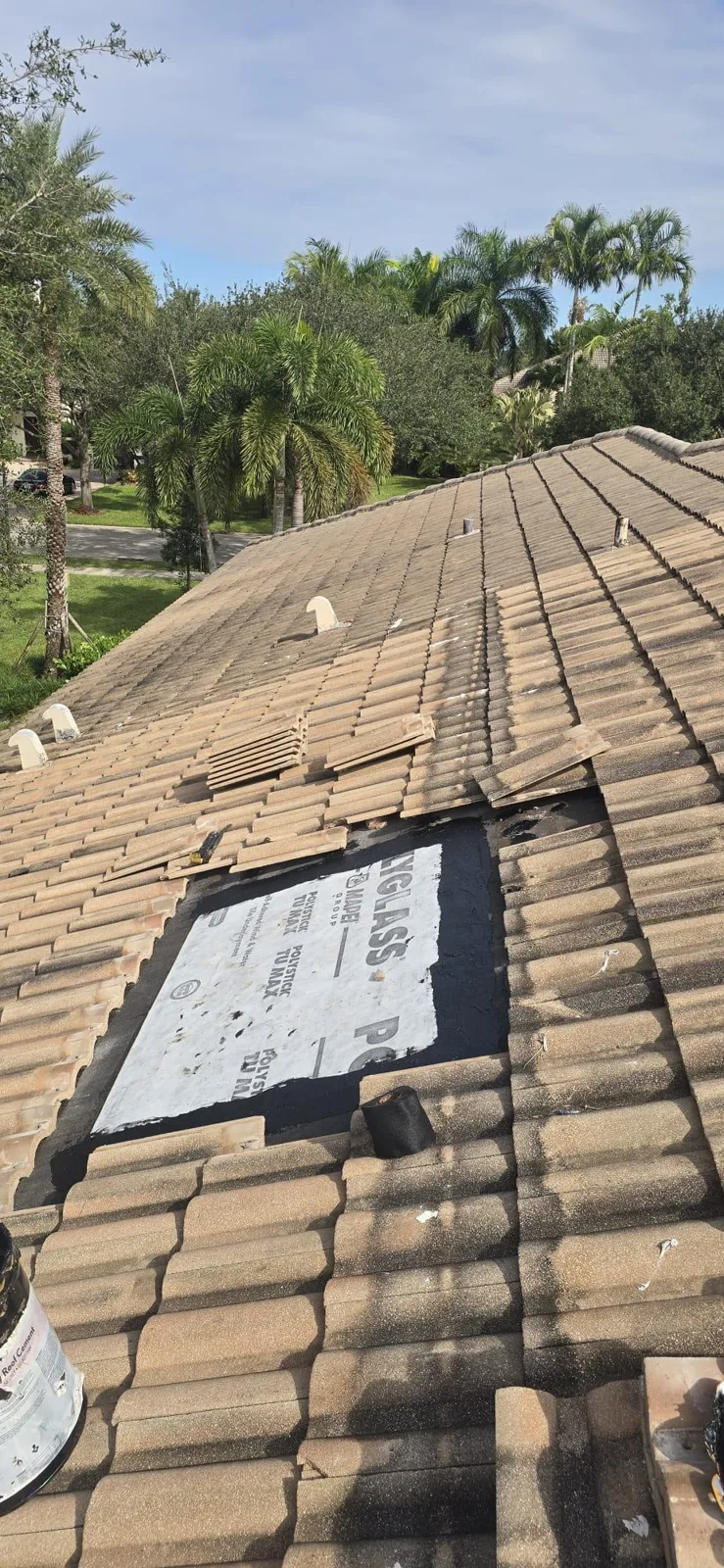 Tile roof with open area and membrane installed during repair