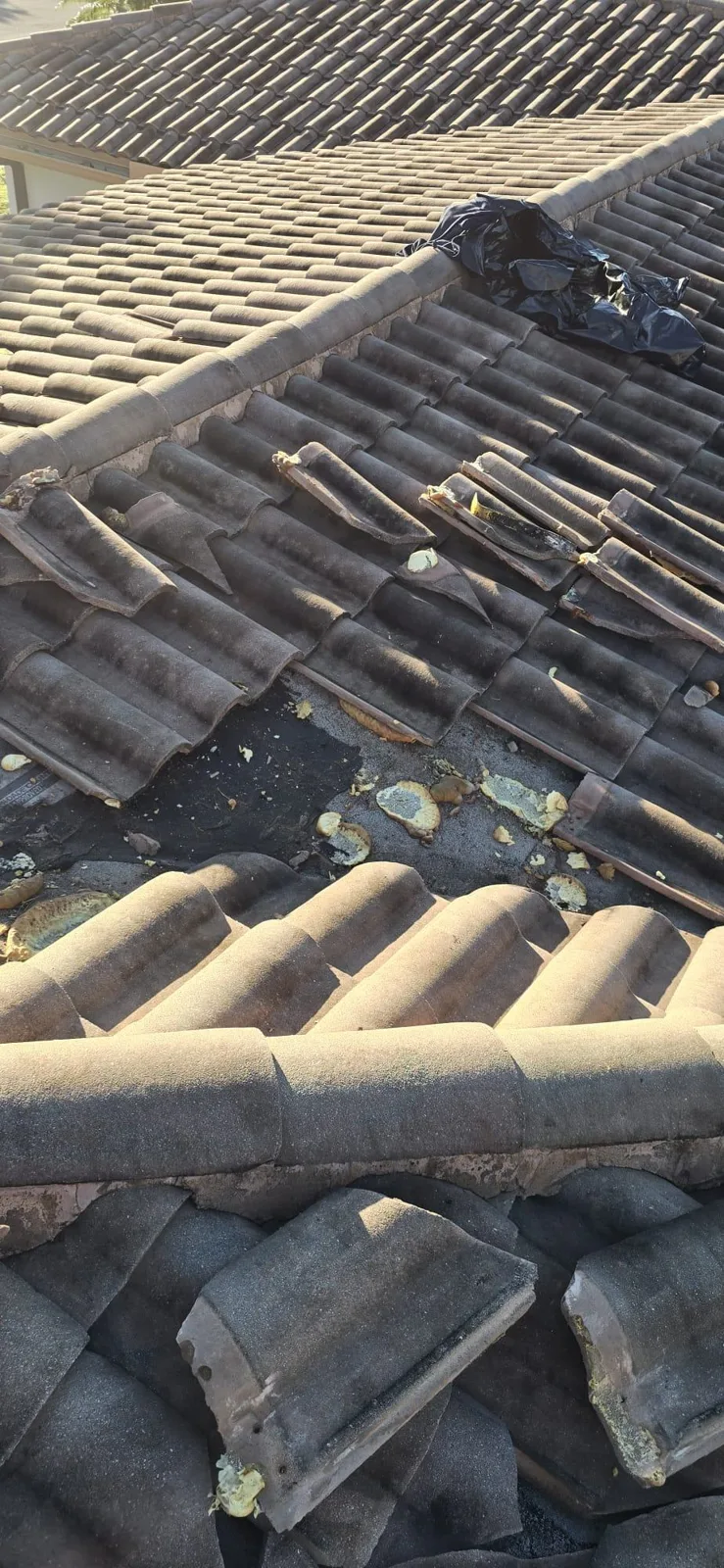 Tiles removed and stacked on the roof during repair