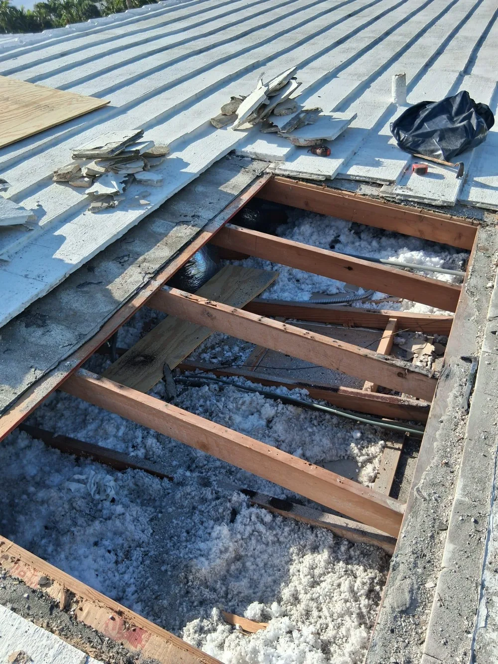 Metal roof with exposed wood structure during repair