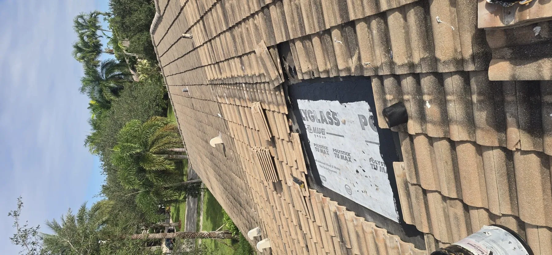 Tile roof repaired by DIOS ES MI FUERZA CORP under a clear sky